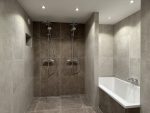 Luxe badkamer met dubbele inloopdouche, vrijstaand bad en grote tegels voor een strakke, moderne uitstraling.